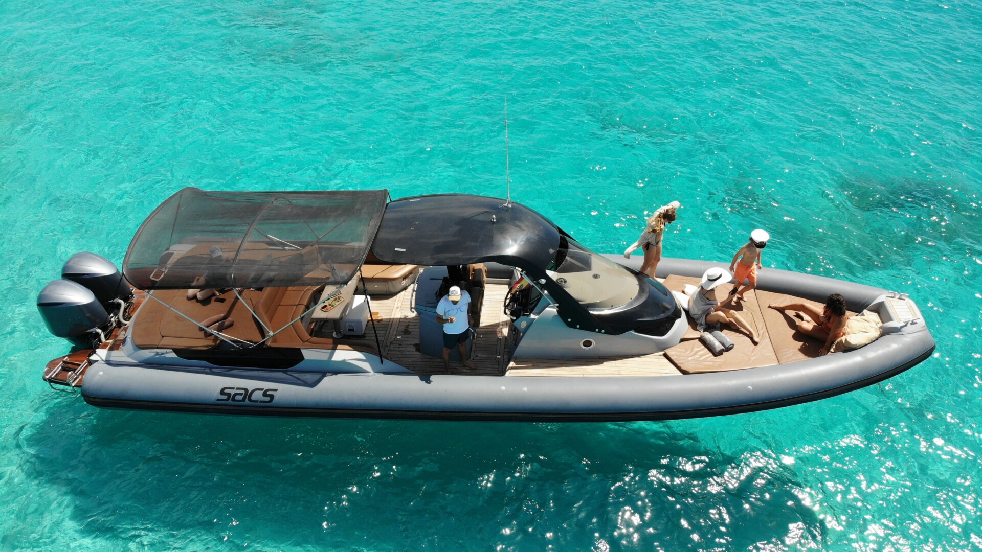 Sacs Strider 13 boat on turquoise waters in Ibiza